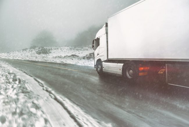 White Modern Truck Moving Fast In Winter On A Road With Snow